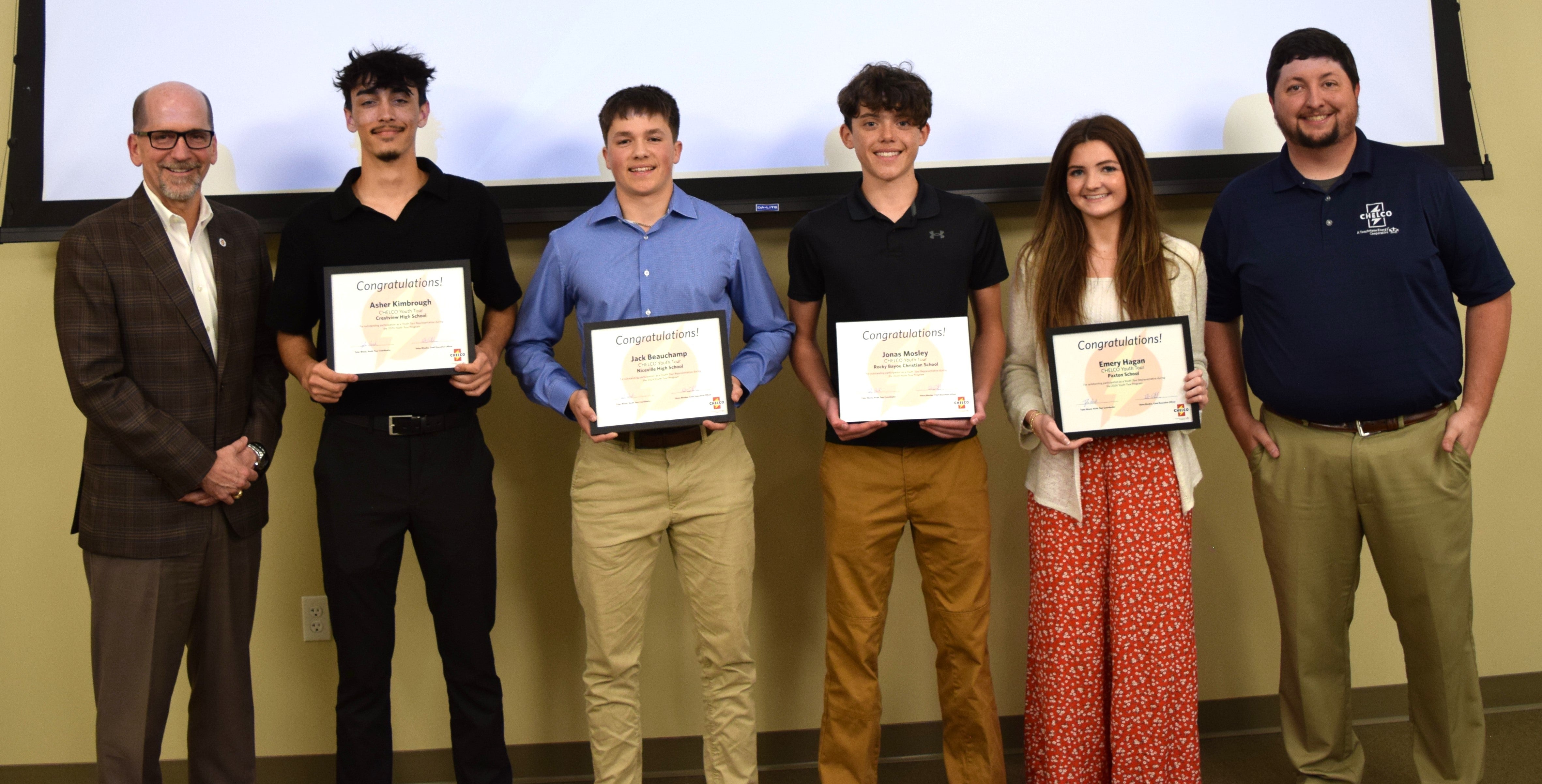 CEO Steve Rhodes, winners Asher Kimbrough (Crestview), Jack Beauchamp (Niceville), Jonas Mosley (Rocky Bayou), Emery Hagan (Paxton), Youth Tour Coordinator Tyler Wood.